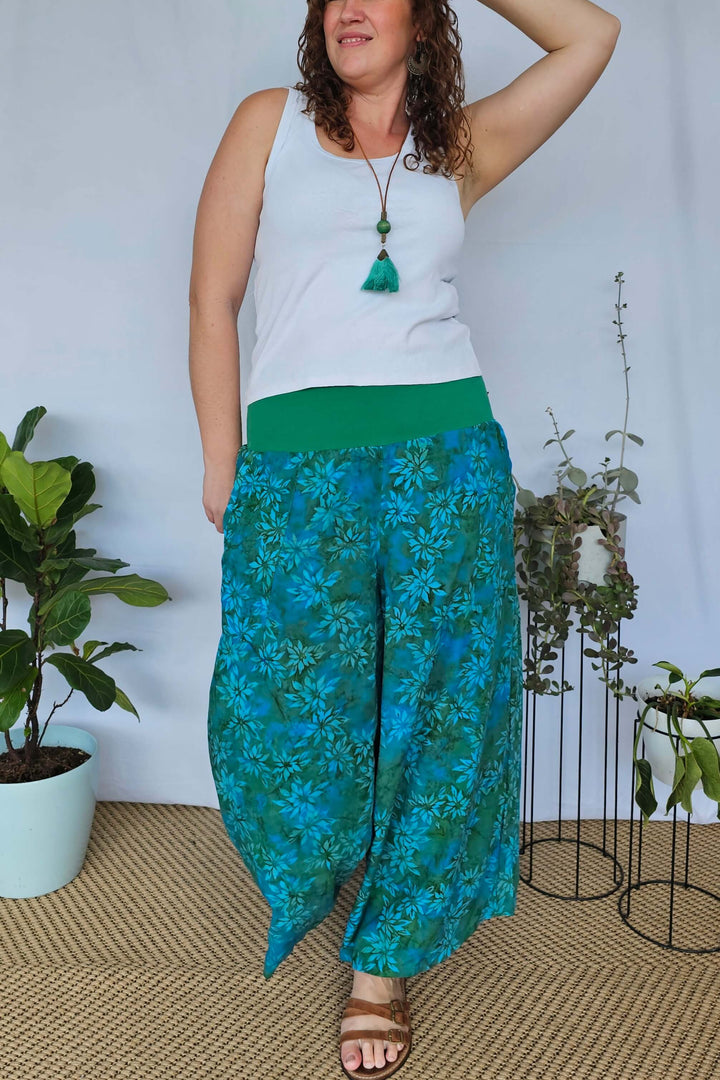 Casual styling of teal wide leg pants with sandals and tank top