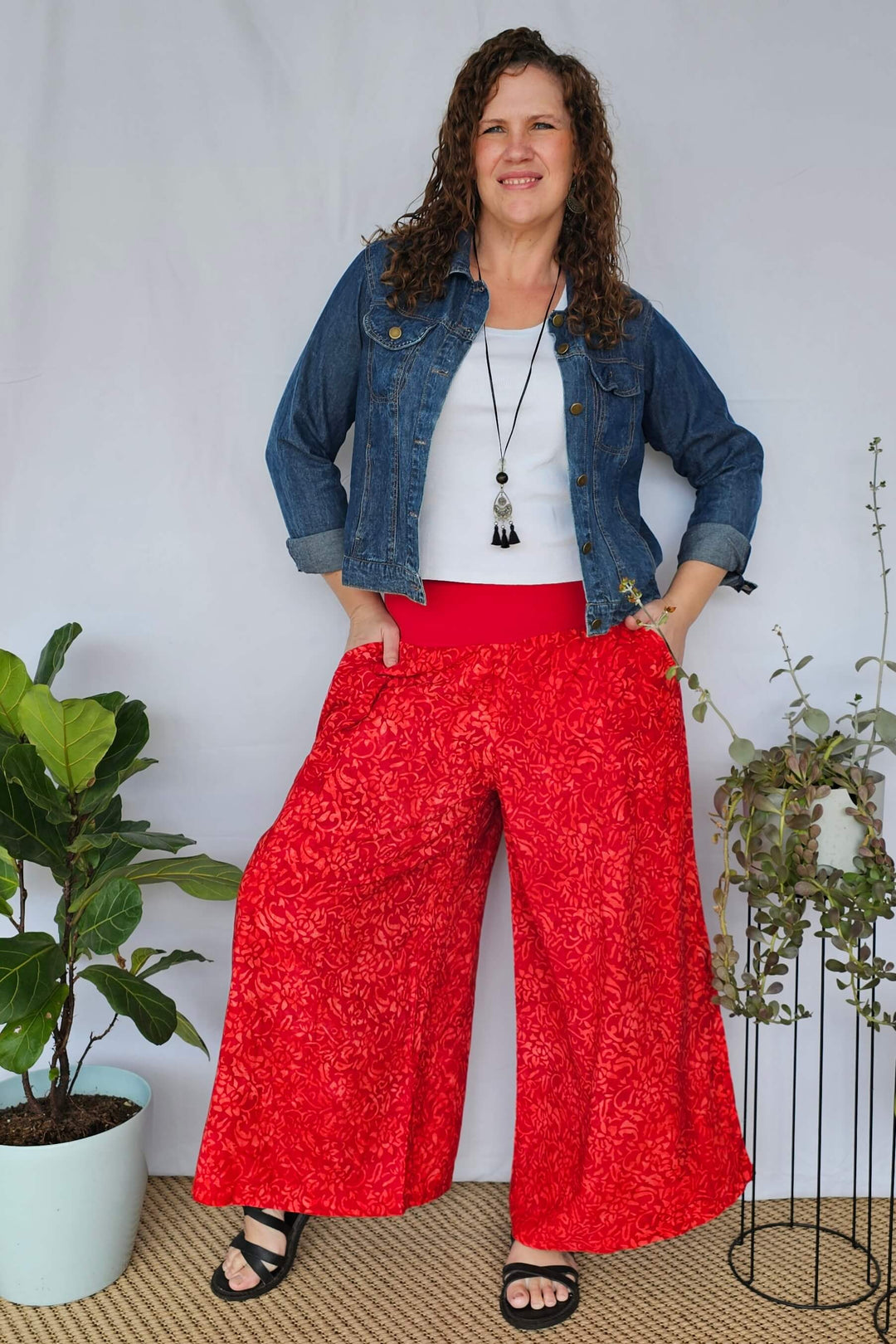 Model styling pants with denim jacket and sandals - casual outfit idea