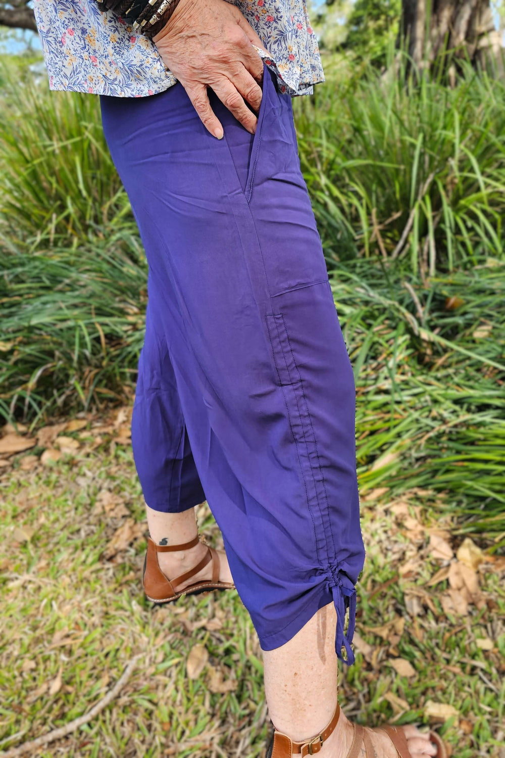 Person wearing navy pants with adjustable hem ties