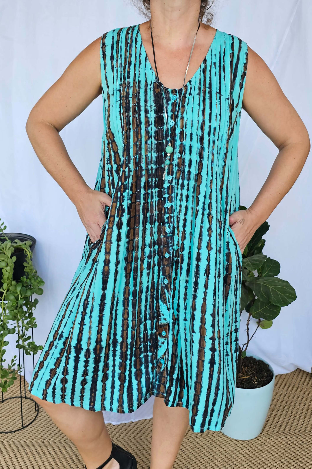 Close-up of Sea Breeze tie dye rayon fabric showing the soft texture and unique aqua, navy and brown pattern.