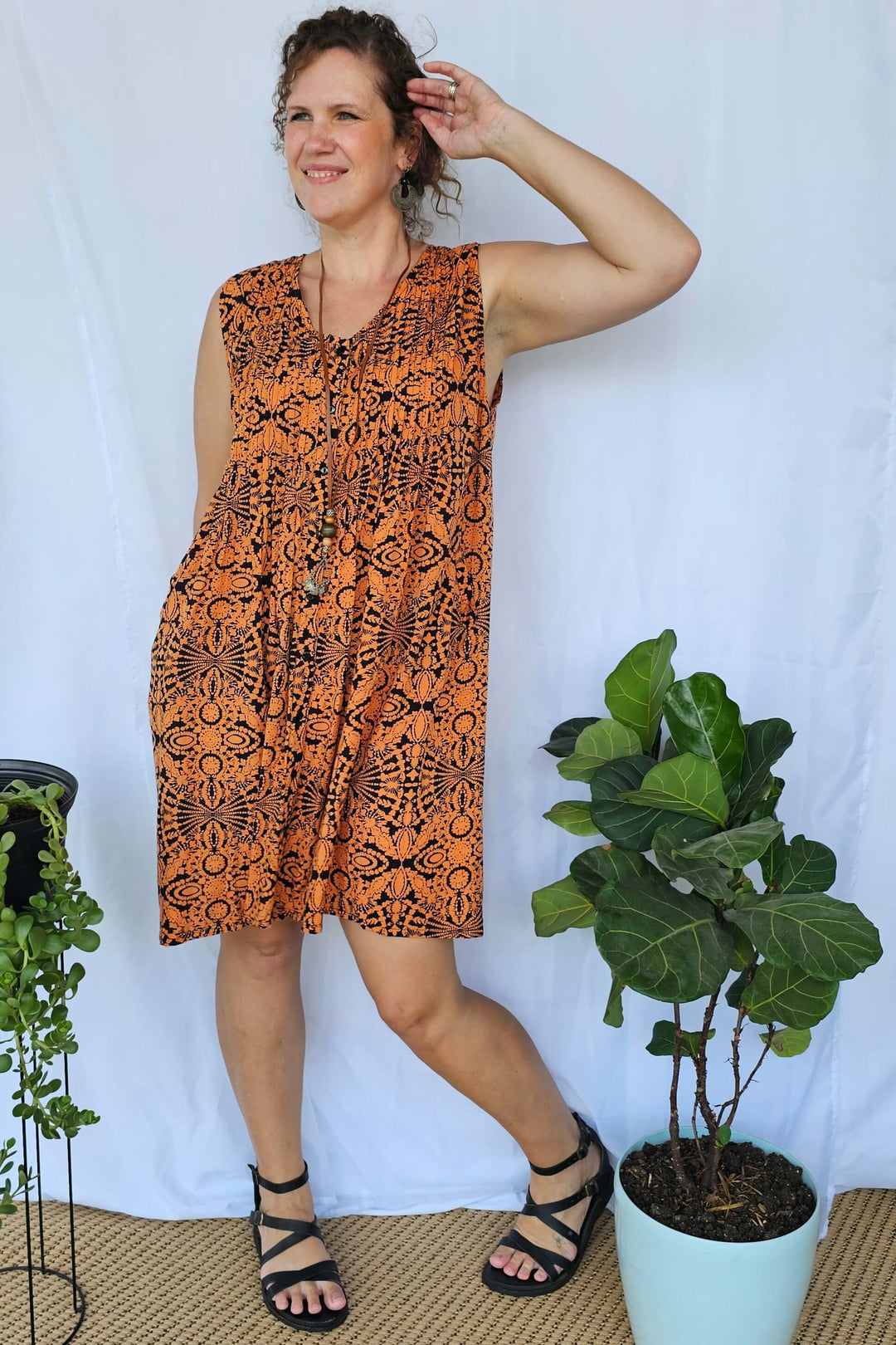 Model wearing Orange Mandala Raya Dress featuring vibrant mandala print and relaxed sleeveless silhouette.