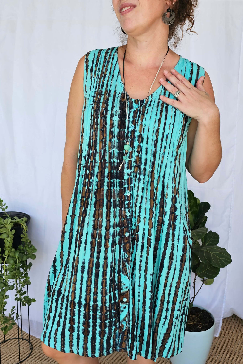 Close-up of Sea Breeze tie dye rayon fabric showing the soft texture and unique aqua, navy and brown pattern.