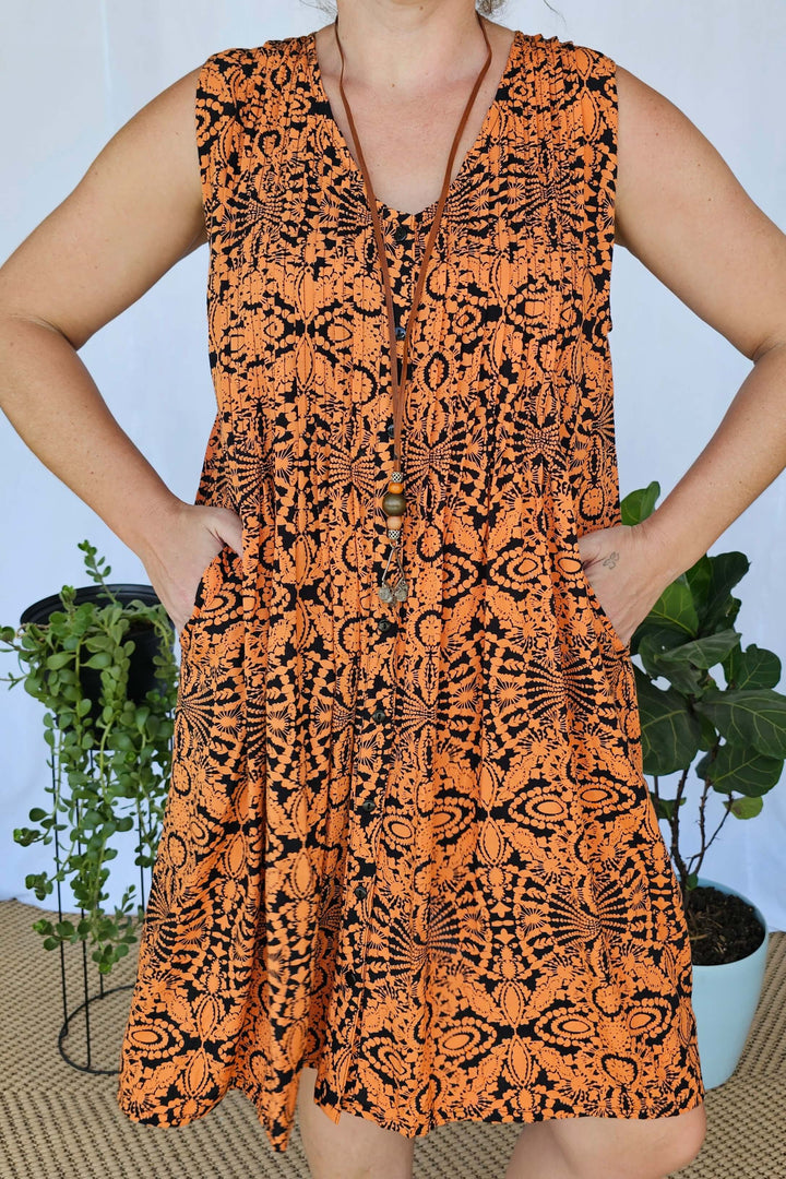 Close-up of Orange Mandala tie dye rayon fabric showing the intricate pattern and soft texture.