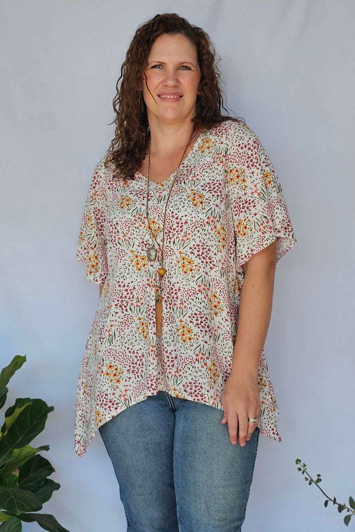 Close-up of warm floral print on rayon fabric – Springtime Ola Top